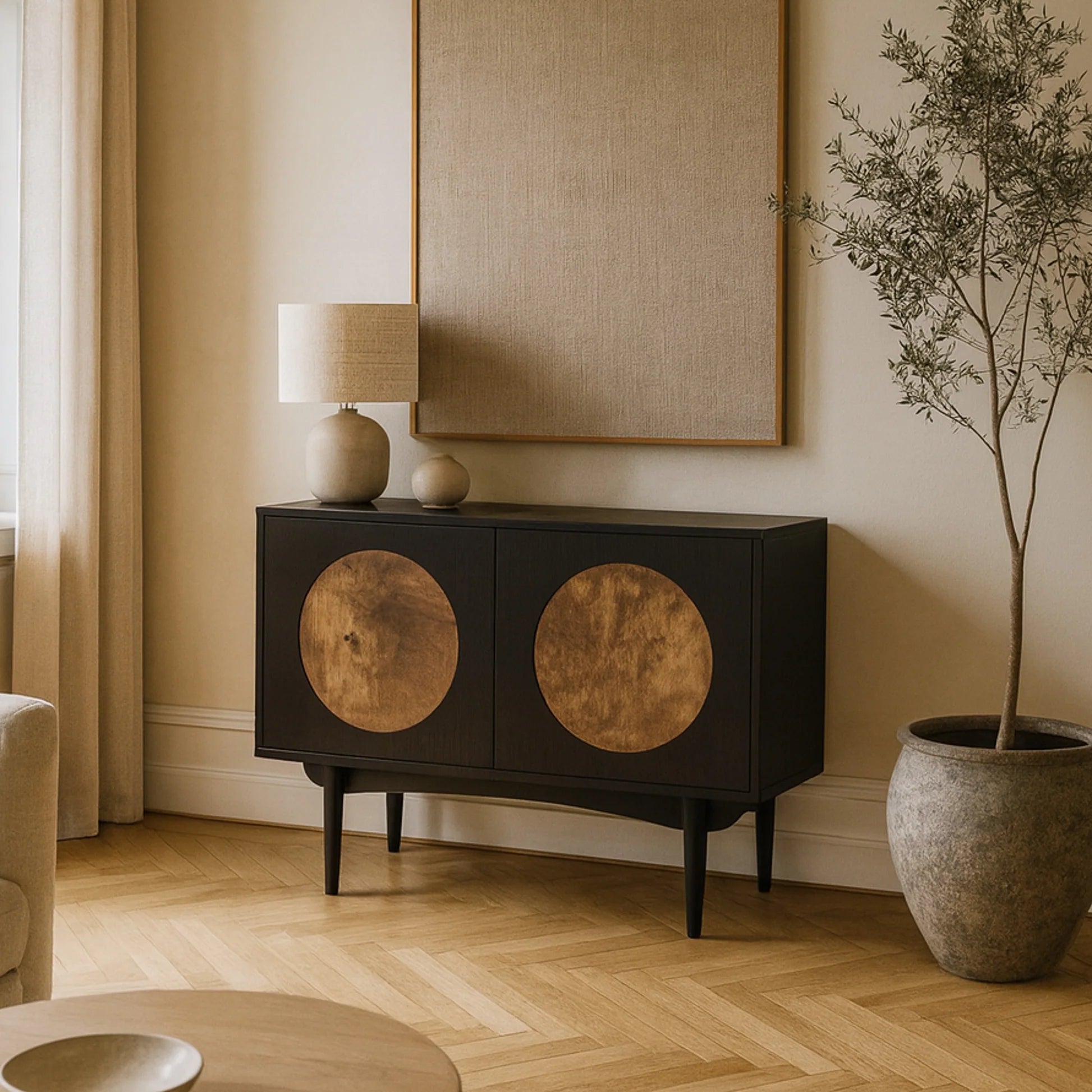 Black cabinet with circular designs in a living room setting